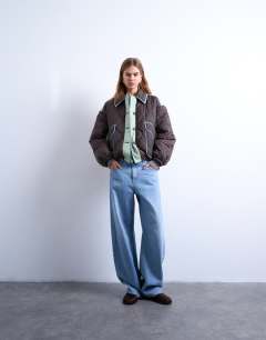 Model wearing Patchwork quilted shacket with contrast piping in blue