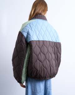 Model wearing Patchwork quilted shacket with contrast piping in blue
