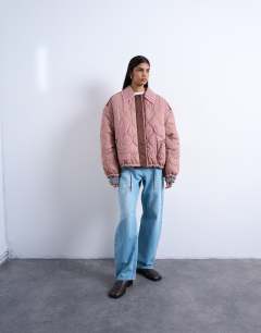 Model wearing Patchwork quilted shacket with contrast piping in pink