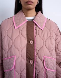 Model wearing Patchwork quilted shacket with contrast piping in pink