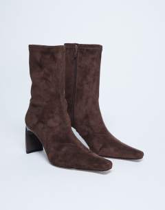 Model wearing Pearl point toe faux suede ankle boot in chocolate