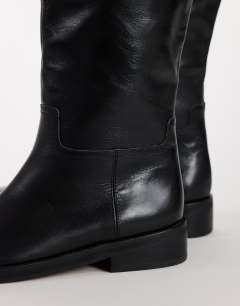 Model wearing Penelope real leather riding boot in black