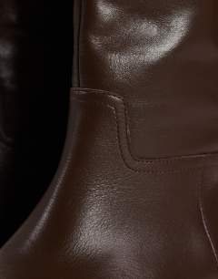 Model wearing Penelope real leather riding boot in chocolate