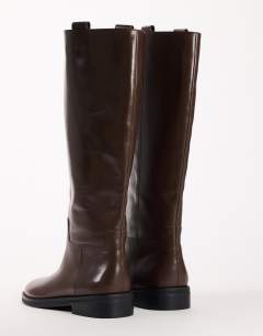 Model wearing Penelope real leather riding boot in chocolate