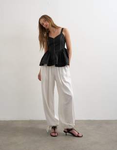 Model wearing Peplum stitch detail cami in black