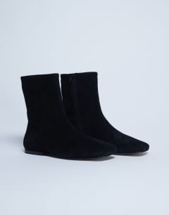 Model wearing Peri real suede flat square toe boot in black