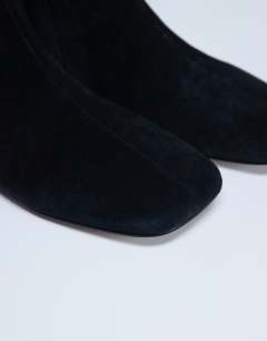 Model wearing Peri real suede flat square toe boot in black