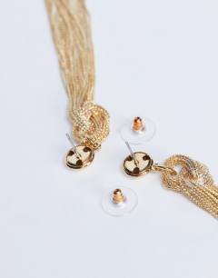 Model wearing Perl tassel earrings in gold