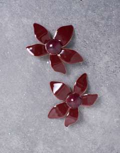 Model wearing Petal flower earrings in burgundy