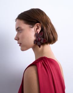 Model wearing Petal flower earrings in burgundy