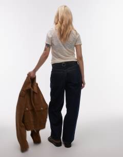 Model wearing Petite Cinch low rise relaxed jean in raw look indigo