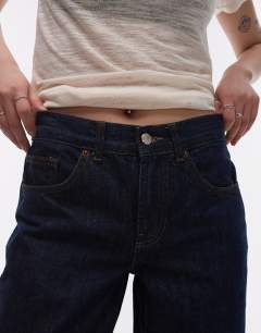 Model wearing Petite Cinch low rise relaxed jean in raw look indigo