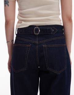 Model wearing Petite Cinch low rise relaxed jean in raw look indigo 