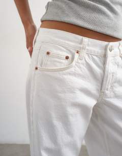 Model wearing Petite Ember low rise straight jean in white
