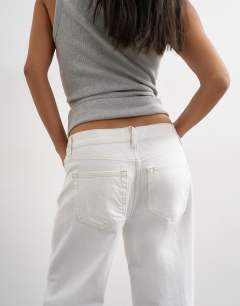 Model wearing Petite Ember low rise straight jean in white
