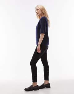 Model wearing Petite Jamie high rise skinny jean in black