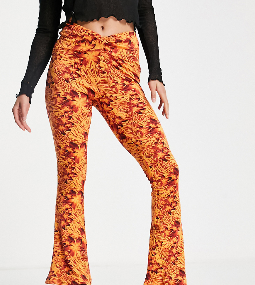 Topshop Petite knot twist front flared trouser in orange hibiscus print-Pink