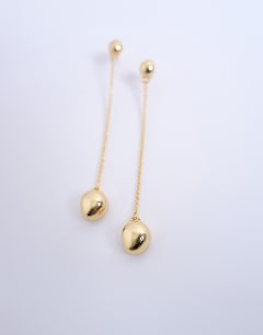 Model wearing Petra gold plated stud earring with chain in gold