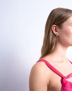 Model wearing Petra silver plated stud earing with chain in silver