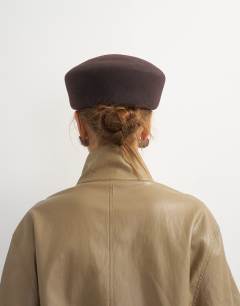 Model wearing Pillbox hat in chocolate