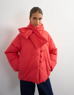 Model wearing Pillow removable scarf puffer jacket in red