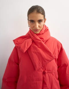 Model wearing Pillow removable scarf puffer jacket in red