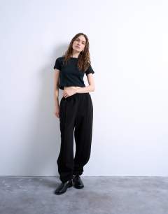Model wearing Pintuck cuffed jogger in black
