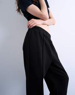 Model wearing Pintuck cuffed jogger in black