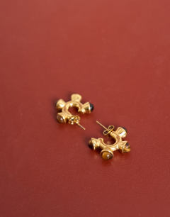 Model wearing Piper stainless steel hoop earrings with stones in gold & tiger