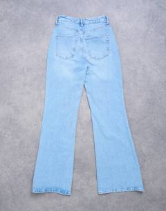 Model wearing Pippa mid rise comfort stretch flare jean in bleach