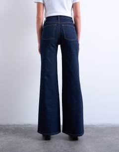 Model wearing Pippa mid rise comfort stretch flare jean in indigo rinse