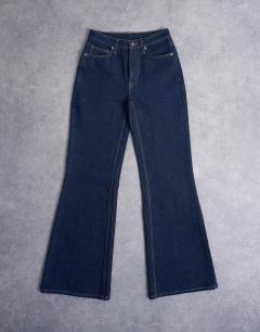 Model wearing Pippa mid rise comfort stretch flare jean in indigo rinse