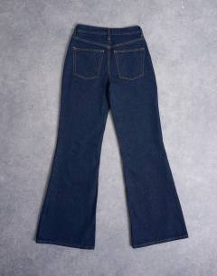 Model wearing Pippa mid rise comfort stretch flare jean in indigo rinse