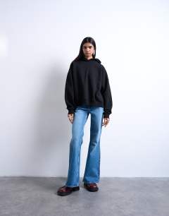 Model wearing Pippa mid rise comfort stretch flare jean in mid blue