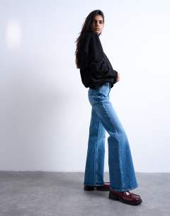 Model wearing Pippa mid rise comfort stretch flare jean in mid blue