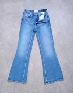 Model wearing Pippa mid rise comfort stretch flare jean in vintage blue