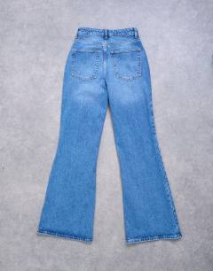 Model wearing Pippa mid rise comfort stretch flare jean in vintage blue