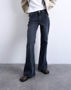 Model wearing Pippa mid rise comfort stretch flare jean in washed black