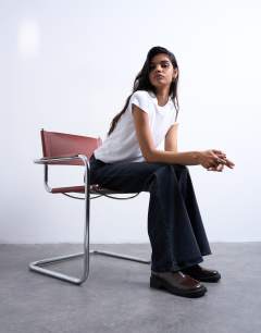 Model wearing Pippa mid rise comfort stretch flare jean in washed black