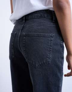 Model wearing Pippa mid rise comfort stretch flare jean in washed black