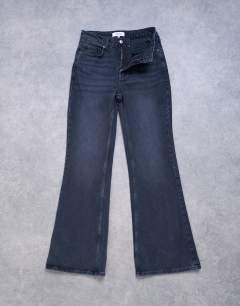 Model wearing Pippa mid rise comfort stretch flare jean in washed black