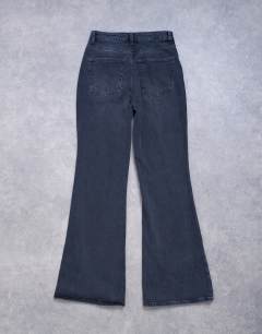 Model wearing Pippa mid rise comfort stretch flare jean in washed black