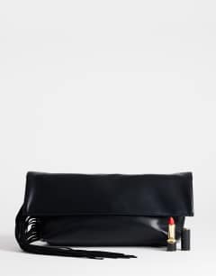 Model wearing Pippa oversized fringe clutch bag in black