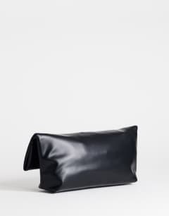 Model wearing Pippa oversized fringe clutch bag in black