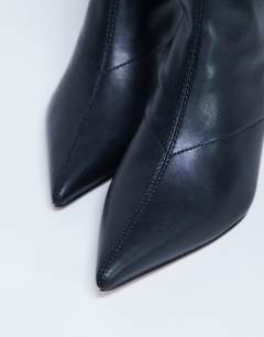 Model wearing Pippa point toe stretch ankle boot in black