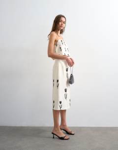 Model wearing Placement embroidery satin cami in cream