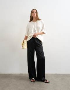 Model wearing Plain satin tie waist wide leg trouser in black