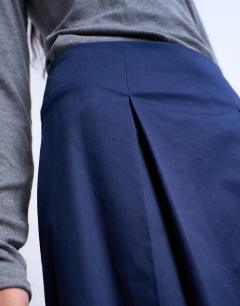 Model wearing Pleat front midi skirt in navy