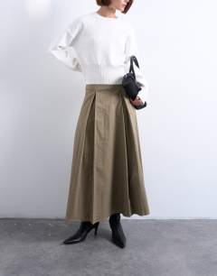 Model wearing Pleat front midi skirt in stone