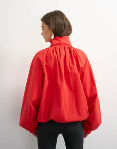 Model wearing Pleated funnel neck anorak in red